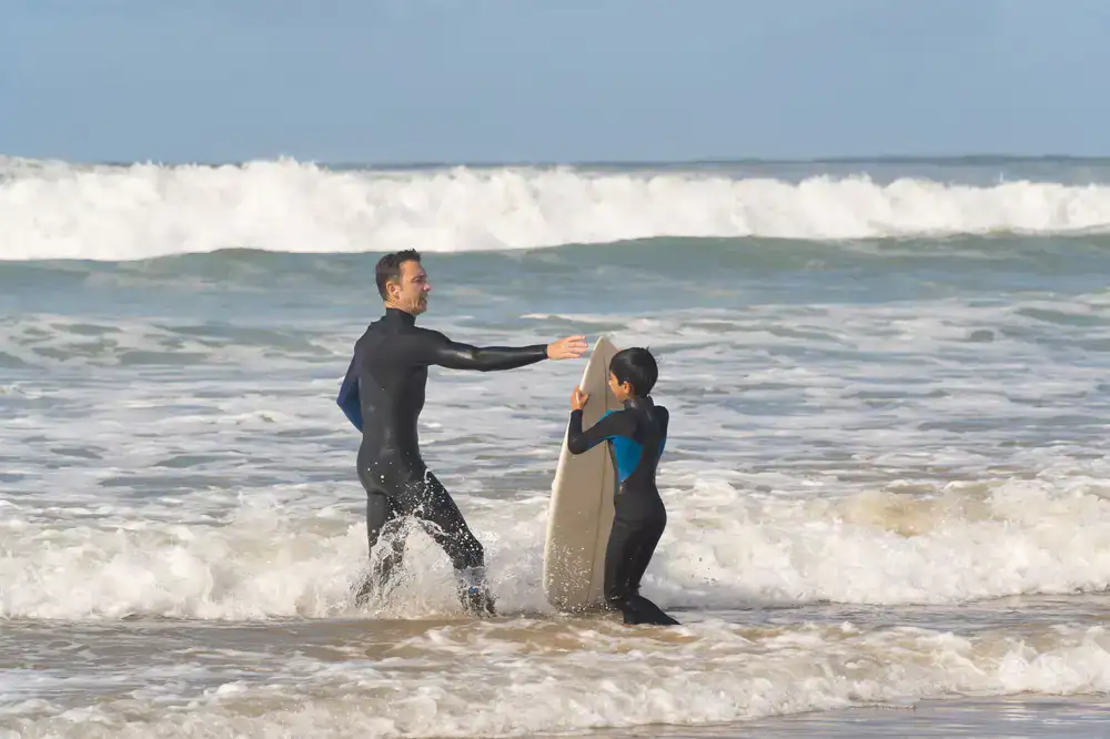 Surfer adjusting wetsuit hardware