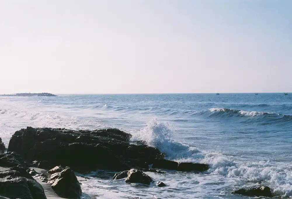 Coastal waves rolling in at sunrise