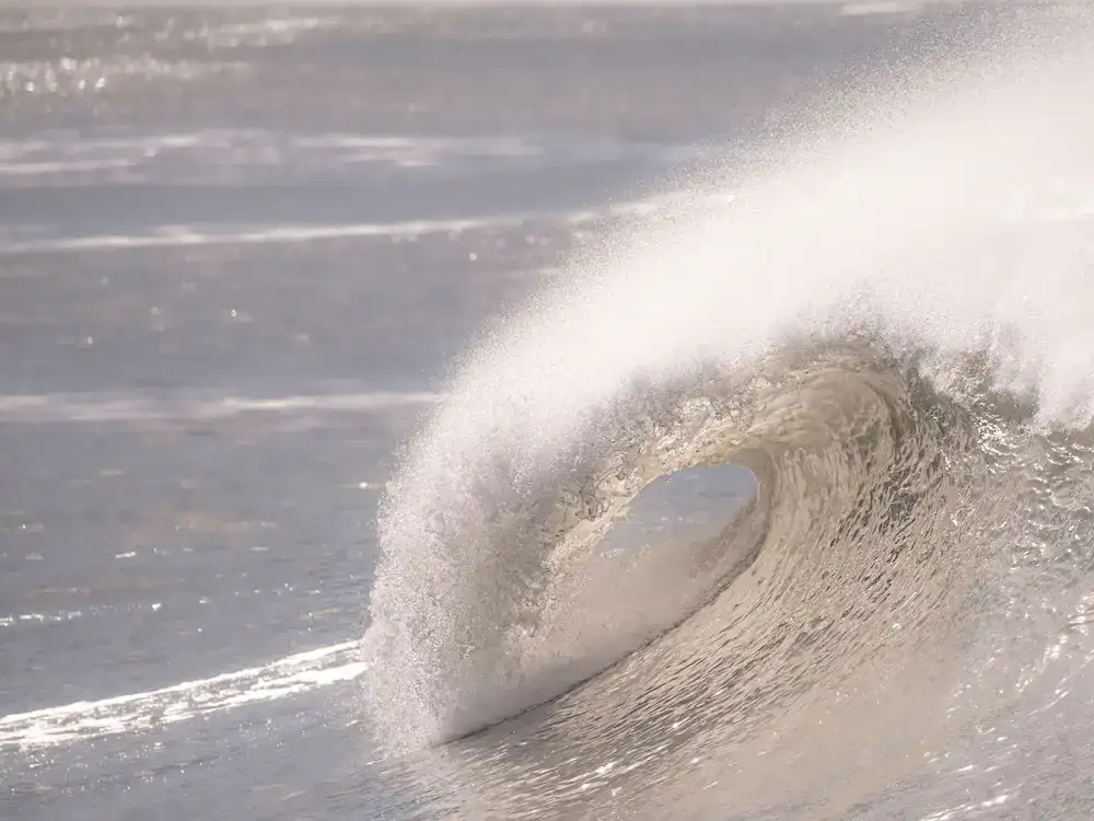 Hollow wave breaking over a shallow reef